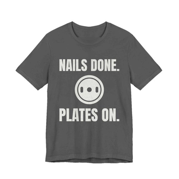 Asphalt t-shirt printed in off-white ink with a weight plate between the words "Nails Done." and "Plates On."