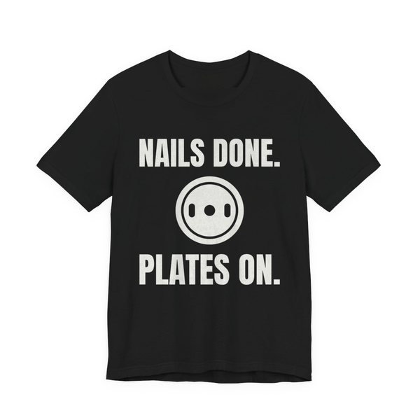 Black t-shirt printed in off-white ink with a weight plate between the words "Nails Done." and "Plates On."