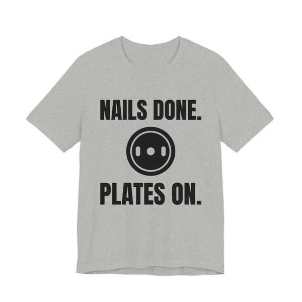 Athletic Heather t-shirt printed in dark ink with a weight plate between the words "Nails Done." and "Plates On."