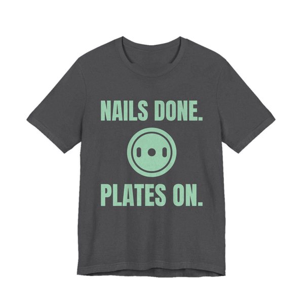 Dark Grey Heather t-shirt printed in mint green ink with a weight plate between the words "Nails Done." and "Plates On."