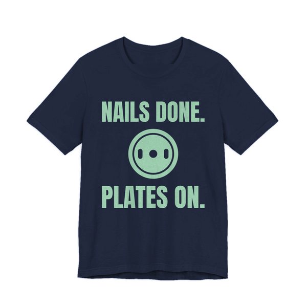 Navy t-shirt printed in mint green ink with a weight plate between the words "Nails Done." and "Plates On."