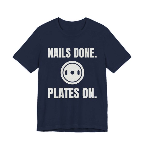 Navy t-shirt printed in off-white ink with a weight plate between the words "Nails Done." and "Plates On."
