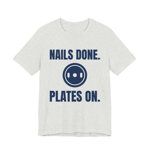Ash t-shirt printed in navy blue ink with a weight plate between the words "Nails Done." and "Plates On."