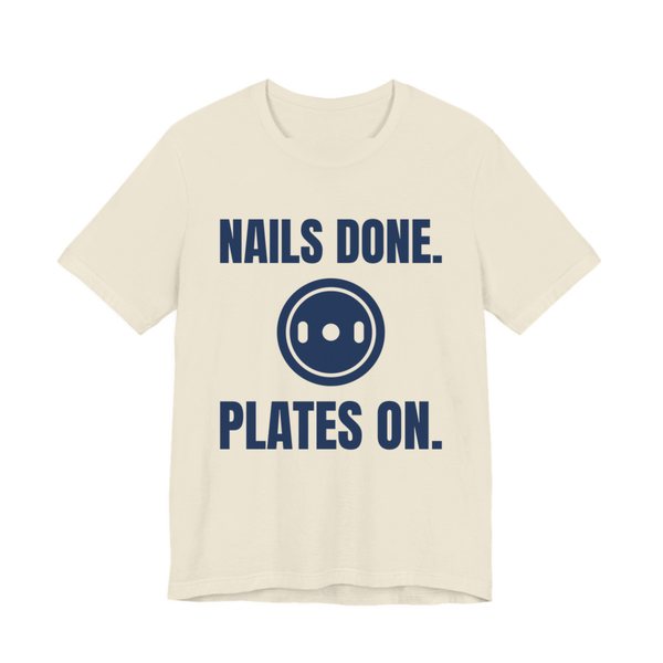 Natural t-shirt printed in navy blue ink with a weight plate between the words "Nails Done." and "Plates On."