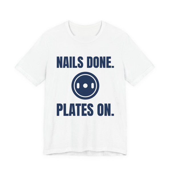 White t-shirt printed in navy blue ink with a weight plate between the words "Nails Done." and "Plates On."