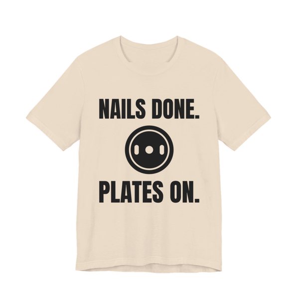 Soft Cream t-shirt printed in dark ink with a weight plate between the words "Nails Done." and "Plates On."