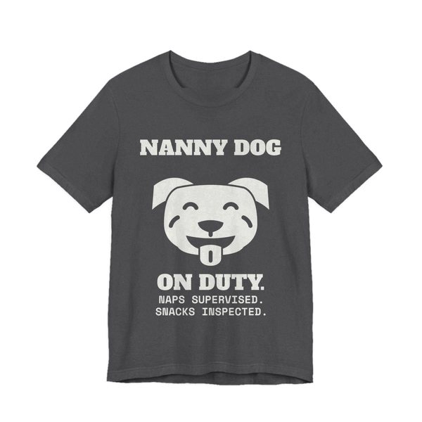 Dark Grey Heather t-shirt printed in off-white ink with a smiling pit bull face and the words “Nanny Dog On Duty. Naps Supervised. Snacks Inspected.”