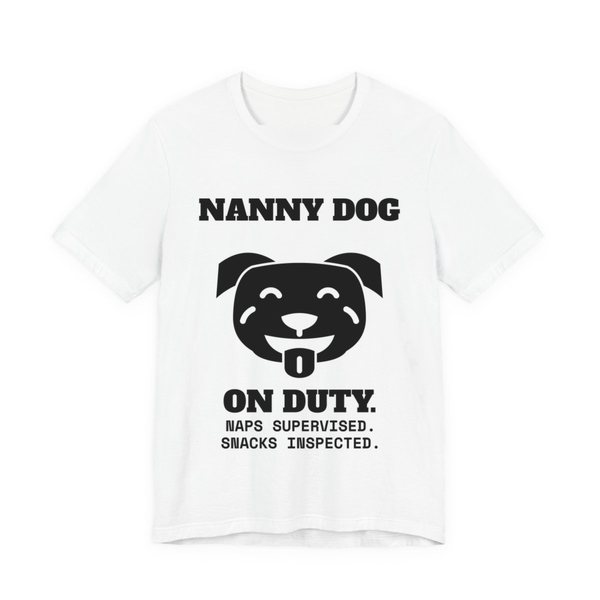 White t-shirt printed in dark ink with a smiling pit bull face and the words “Nanny Dog On Duty. Naps Supervised. Snacks Inspected.”