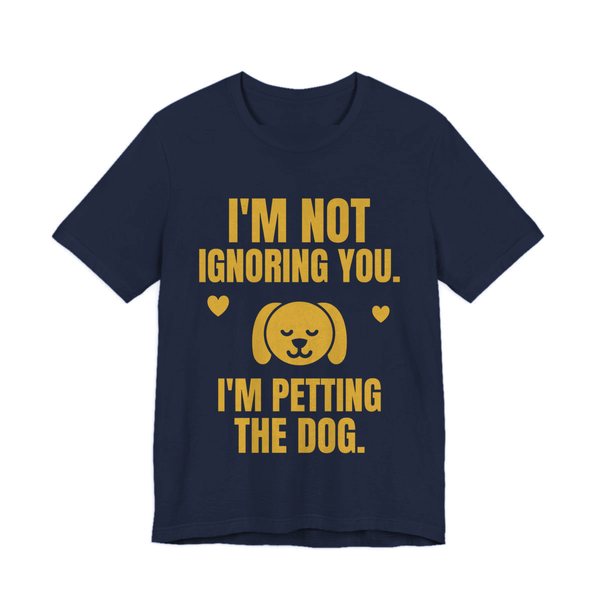 Navy t-shirt printed in gold ink with a content dog face with hearts and the words “I'm Not Ignoring You. I'm Petting the Dog.”