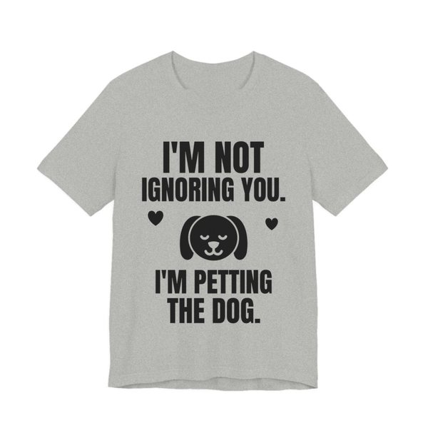 Athletic Heather t-shirt printed in dark ink with a content dog face with hearts and the words “I'm Not Ignoring You. I'm Petting the Dog.”