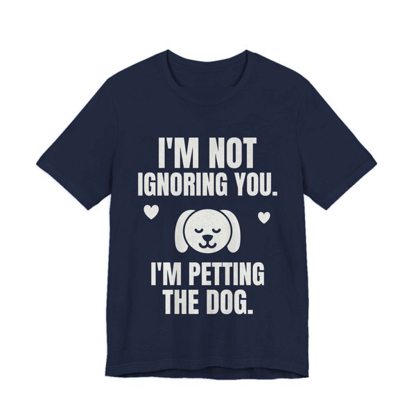 Navy t-shirt printed in off-white ink with a content dog face with hearts and the words “I'm Not Ignoring You. I'm Petting the Dog.”