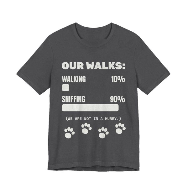 Dark Grey Heather t-shirt printed in off-white ink with a bar chart of walking 10% and sniffing 90%, paw prints and the words “Our Walks.” (We are not in a hurry.)