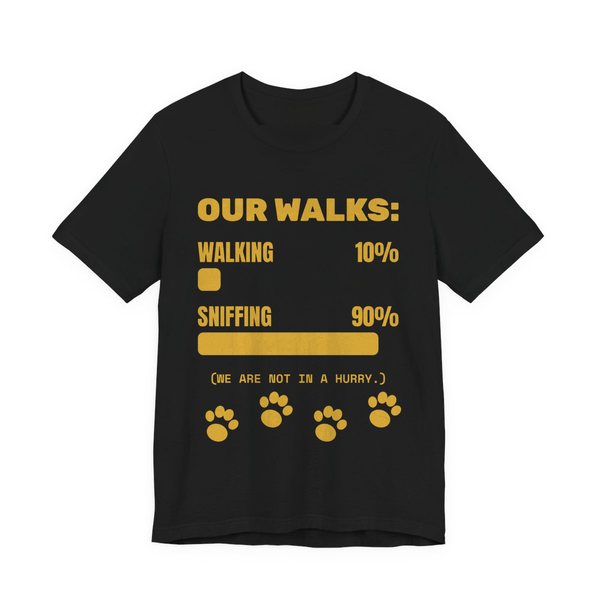 Black t-shirt printed in gold ink with a bar chart of walking 10% and sniffing 90%, paw prints and the words “Our Walks.” (We are not in a hurry.)