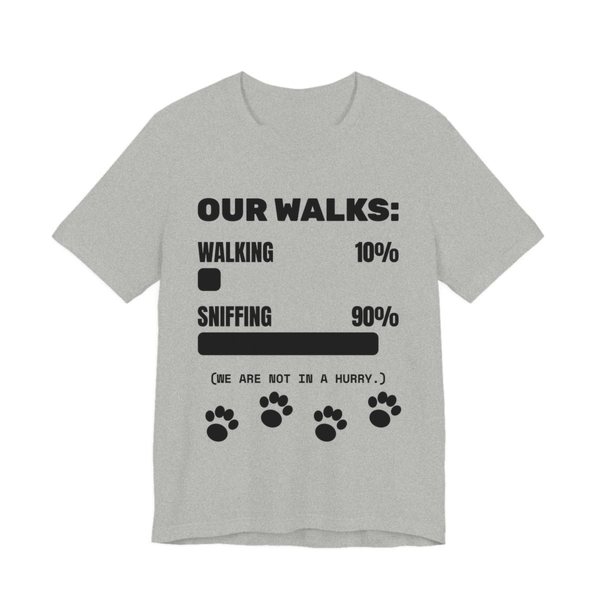 Athletic Heather t-shirt printed in dark ink with a bar chart of walking 10% and sniffing 90%, paw prints and the words “Our Walks.” (We are not in a hurry.)