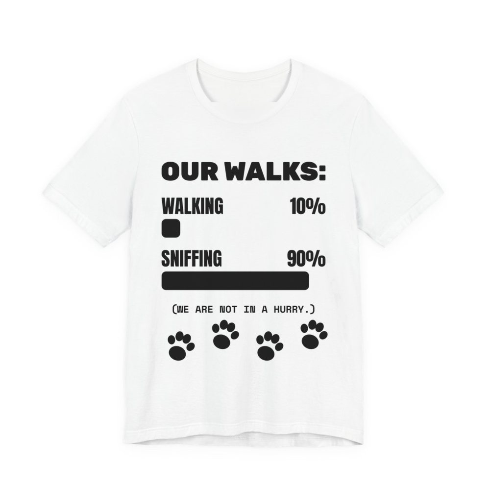 White t-shirt printed in dark ink with a bar chart of walking 10% and sniffing 90%, paw prints and the words “Our Walks.” (We are not in a hurry.)
