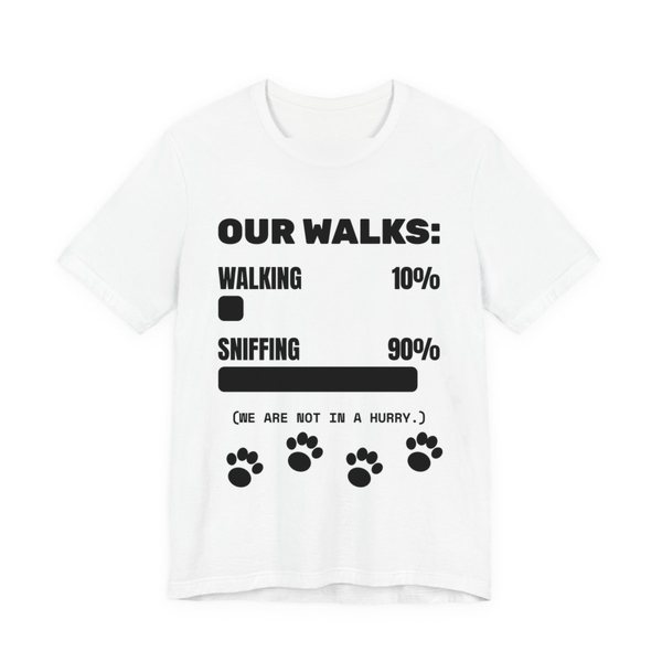 White t-shirt printed in dark ink with a bar chart of walking 10% and sniffing 90%, paw prints and the words “Our Walks.” (We are not in a hurry.)