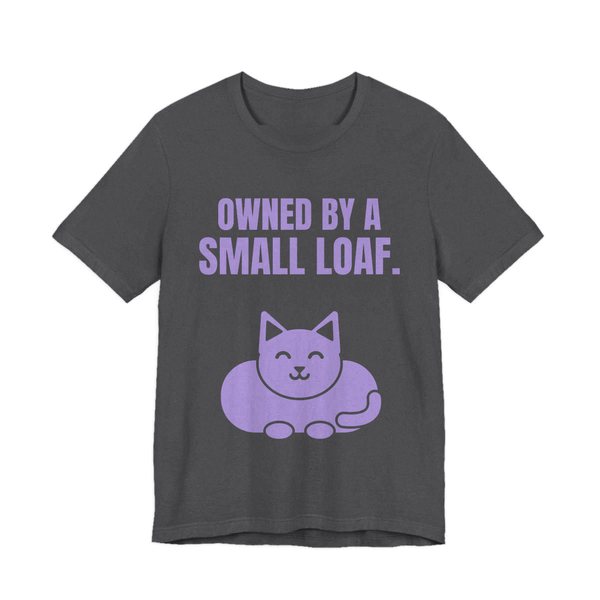 Dark Grey Heather t-shirt printed in lavender ink with a loaf-shaped cat and the words “Owned by a Small Loaf.”