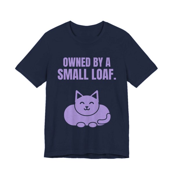 Navy t-shirt printed in lavender ink with a loaf-shaped cat and the words “Owned by a Small Loaf.”
