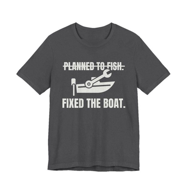 Dark Grey Heather t-shirt printed in off-white ink with a boat and a wrench, with “Planned to Fish.” crossed out above “Fixed the Boat.”