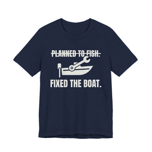 Navy t-shirt printed in off-white ink with a boat and a wrench, with “Planned to Fish.” crossed out above “Fixed the Boat.”