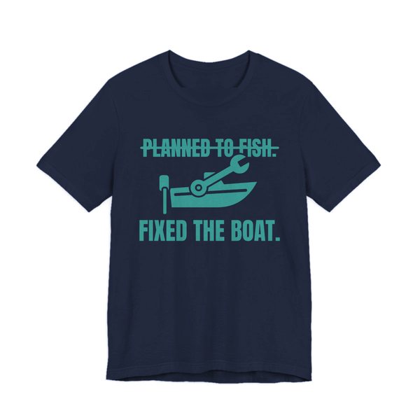 Navy t-shirt printed in teal ink with a boat and a wrench, with “Planned to Fish.” crossed out above “Fixed the Boat.”
