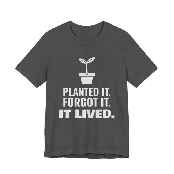 Dark Grey Heather t-shirt printed in off-white ink with a sprout in a flowerpot and the words “Planted It. Forgot It. It Lived.”