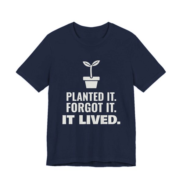 Navy t-shirt printed in off-white ink with a sprout in a flowerpot and the words “Planted It. Forgot It. It Lived.”