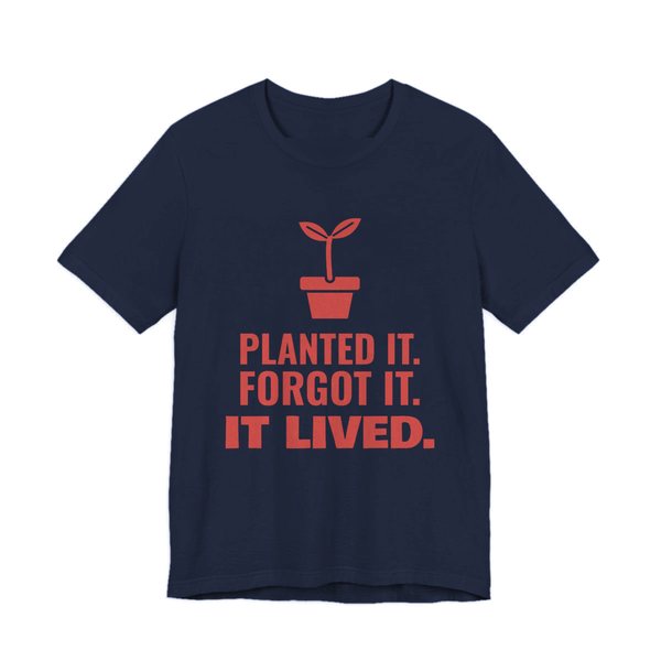 Navy t-shirt printed in tomato red ink with a sprout in a flowerpot and the words “Planted It. Forgot It. It Lived.”