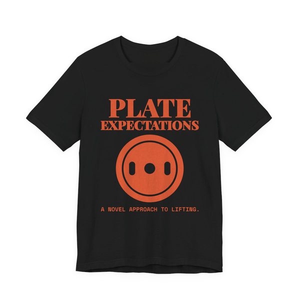 Black t-shirt printed in orange ink with a weight plate and the words “Plate Expectations. A Novel Approach to Lifting.”