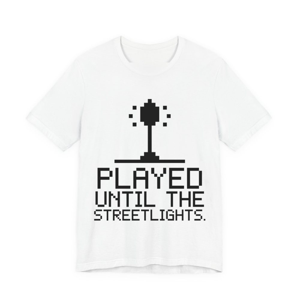 White t-shirt printed in dark ink with a pixel streetlight and the words “Played Until the Streetlights.”