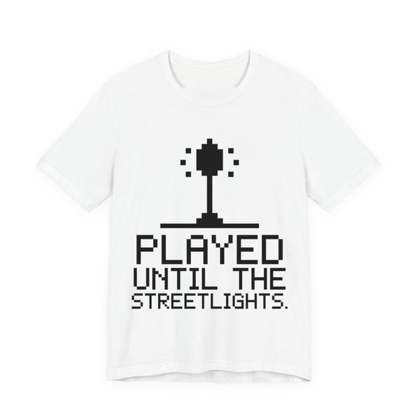 White t-shirt printed in dark ink with a pixel streetlight and the words “Played Until the Streetlights.”