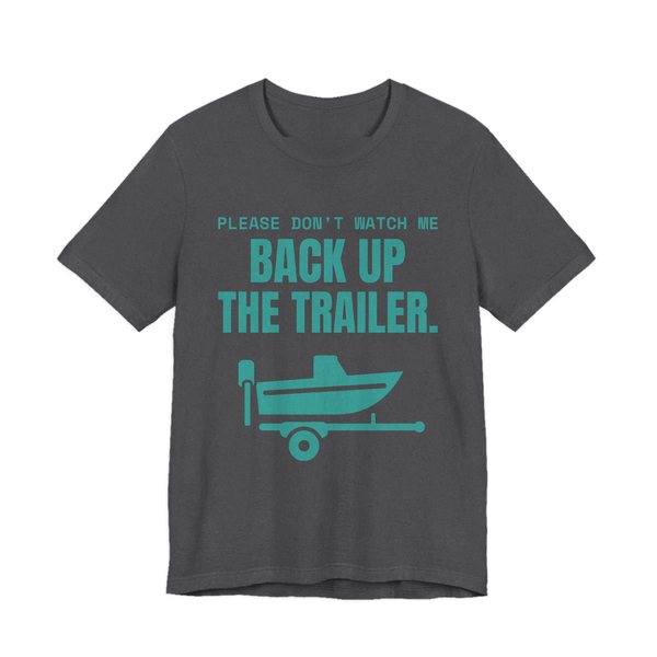 Dark Grey Heather t-shirt printed in teal ink with a boat on a trailer and the words “Please Don't Watch Me Back Up the Trailer.”