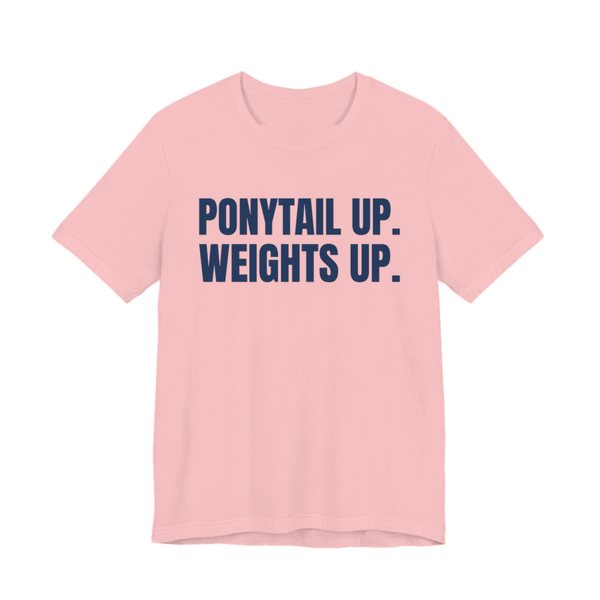 Pink t-shirt printed in navy blue ink with the words "Ponytail Up. Weights Up."