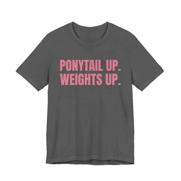 Asphalt t-shirt printed in rose pink ink with the words "Ponytail Up. Weights Up."