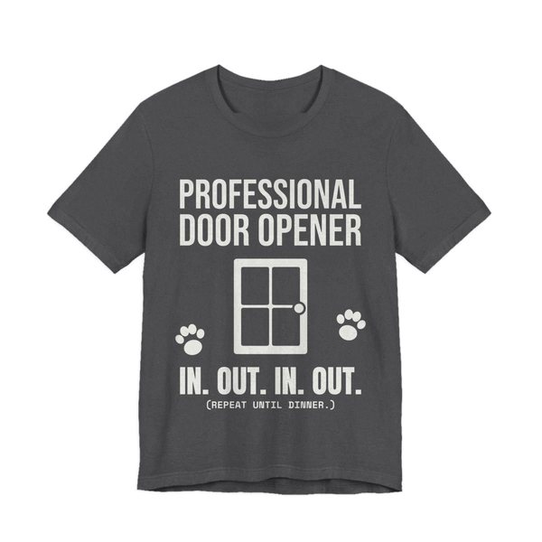 Dark Grey Heather t-shirt printed in off-white ink with a door, paw prints and the words “Professional Door Opener. In. Out. In. Out. (Repeat until dinner.)”