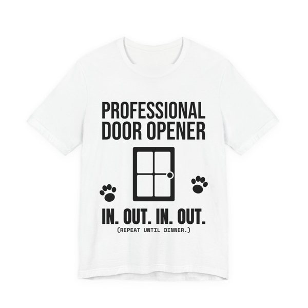 White t-shirt printed in dark ink with a door, paw prints and the words “Professional Door Opener. In. Out. In. Out. (Repeat until dinner.)”