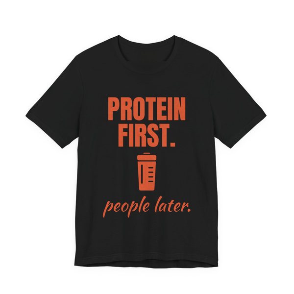 Black t-shirt printed in orange ink with a protein shaker and the words “Protein First. People Later.”