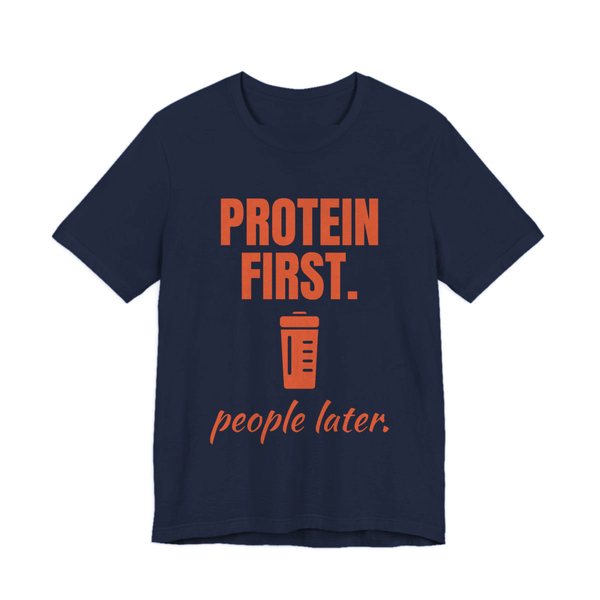 Navy t-shirt printed in orange ink with a protein shaker and the words “Protein First. People Later.”