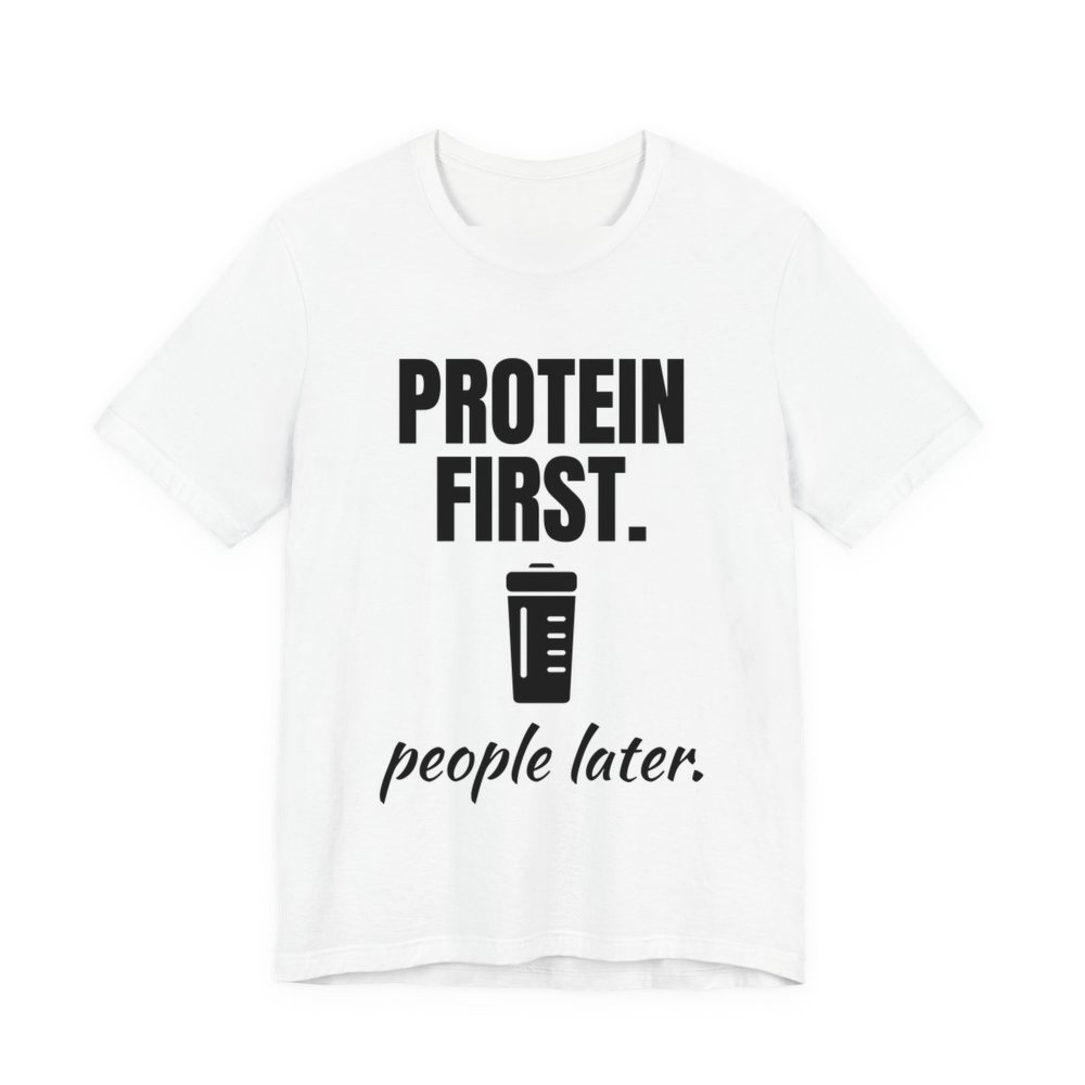 White t-shirt printed in dark ink with a protein shaker and the words “Protein First. People Later.”