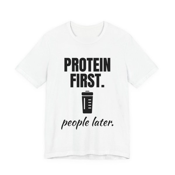 White t-shirt printed in dark ink with a protein shaker and the words “Protein First. People Later.”