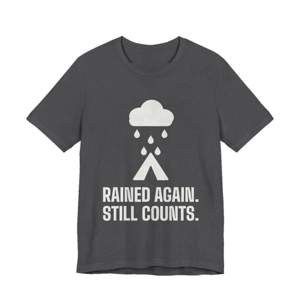 Dark Grey Heather t-shirt printed in off-white ink with a rain cloud over a tent and the words “Rained Again. Still Counts.”