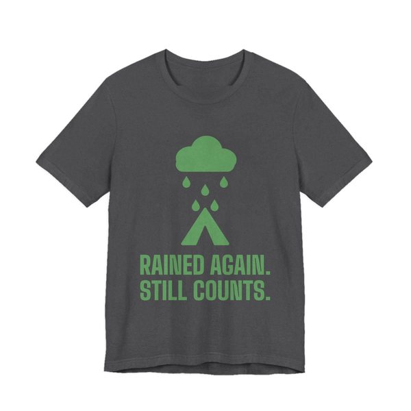 Dark Grey Heather t-shirt printed in pine green ink with a rain cloud over a tent and the words “Rained Again. Still Counts.”