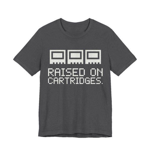 Dark Grey Heather t-shirt printed in off-white ink with three plain pixel cartridges and the words “Raised on Cartridges.”