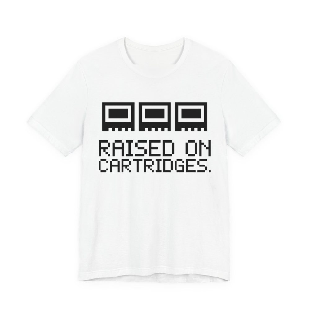 White t-shirt printed in dark ink with three plain pixel cartridges and the words “Raised on Cartridges.”