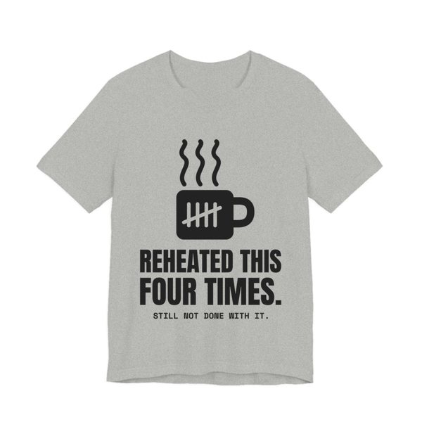 Athletic Heather t-shirt printed in dark ink with a mug with tally marks and the words “Reheated This Four Times.”