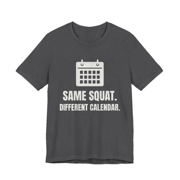 Dark Grey Heather t-shirt printed in off-white ink with a wall calendar and the words “Same Squat. Different Calendar.”
