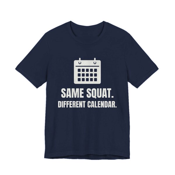 Navy t-shirt printed in off-white ink with a wall calendar and the words “Same Squat. Different Calendar.”