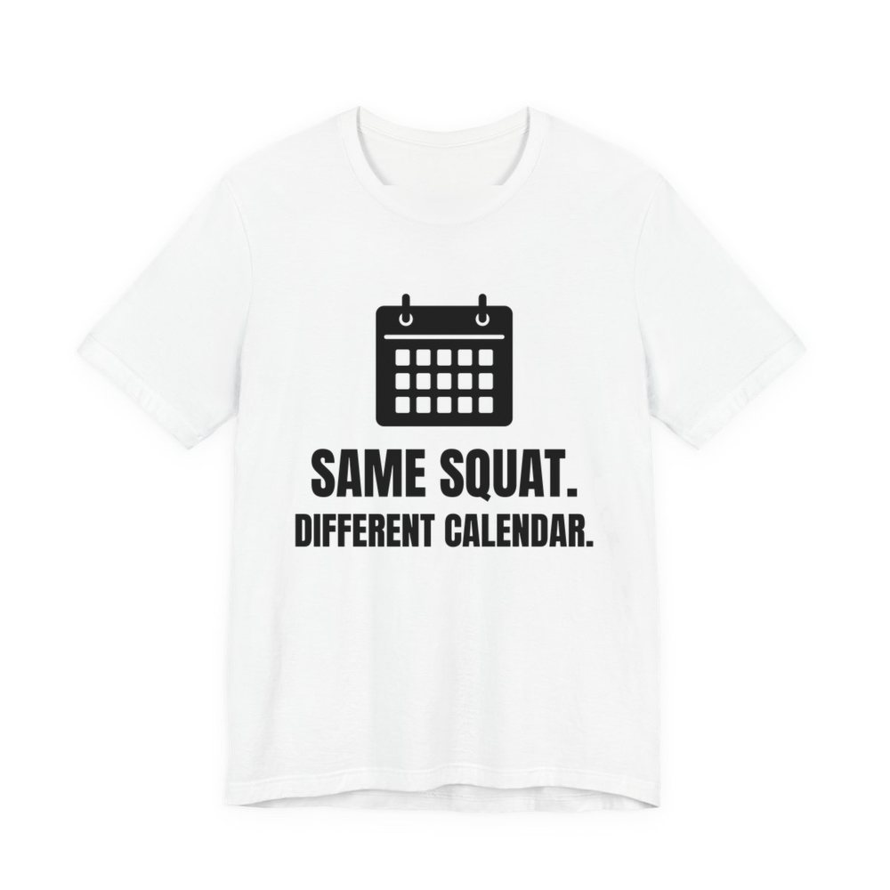 White t-shirt printed in dark ink with a wall calendar and the words “Same Squat. Different Calendar.”
