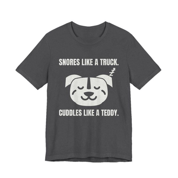 Dark Grey Heather t-shirt printed in off-white ink with a sleeping pit bull face and the words “Snores Like a Truck. Cuddles Like a Teddy.”