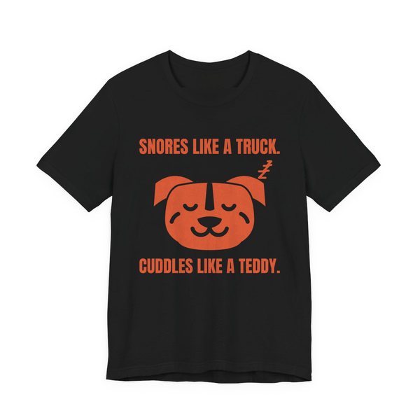 Black t-shirt printed in orange ink with a sleeping pit bull face and the words “Snores Like a Truck. Cuddles Like a Teddy.”
